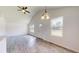 Bright living room with wood-style floors and a view of the front yard at 13627 Sw 103Rd Pl, Dunnellon, FL 34432