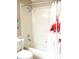 Bathroom showcasing a shower-tub combo with a flamingo curtain, complete with tiled walls at 13686 Sw 111Th Ave, Dunnellon, FL 34432