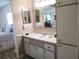 Bright bathroom with a single sink vanity and a peek into an adjacent bedroom at 13686 Sw 111Th Ave, Dunnellon, FL 34432