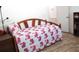 Comfortable bedroom featuring a flamingo-patterned daybed, providing a cozy and stylish space at 13686 Sw 111Th Ave, Dunnellon, FL 34432