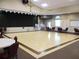 Large community room with stage area and wood flooring, great for dancing and gatherings at 13686 Sw 111Th Ave, Dunnellon, FL 34432