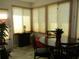 Bright sunroom dining area with marble table, four chairs and lots of natural light at 13686 Sw 111Th Ave, Dunnellon, FL 34432