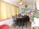 Bright breakfast nook with marble table, four chairs and lots of natural light at 13686 Sw 111Th Ave, Dunnellon, FL 34432