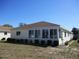 Rear exterior view of home with many windows allowing for abundant natural light and a manicured lawn at 13686 Sw 111Th Ave, Dunnellon, FL 34432