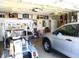 Spacious two-car garage with ample storage and an adjacent golf cart at 13686 Sw 111Th Ave, Dunnellon, FL 34432