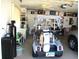 Garage featuring a golf cart, storage shelves, and overhead lighting at 13686 Sw 111Th Ave, Dunnellon, FL 34432