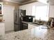 Functional kitchen featuring stainless steel appliances and a large granite countertop at 13686 Sw 111Th Ave, Dunnellon, FL 34432