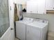 Functional laundry room with white cabinets and a modern washer and dryer set at 13686 Sw 111Th Ave, Dunnellon, FL 34432