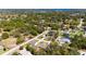 High-angle aerial view of a neighborhood with varied homes, green spaces, and a tranquil atmosphere at 16272 Se 89Th Ct, Summerfield, FL 34491