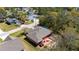 Overhead view of house showing roof, backyard, boat on driveway, and close proximity to neighboring homes and trees at 16272 Se 89Th Ct, Summerfield, FL 34491