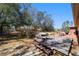 Landscaped backyard featuring a wooden deck and mature trees at 16272 Se 89Th Ct, Summerfield, FL 34491
