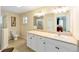 Bright bathroom with double sinks, shower with glass door, and tile flooring at 16272 Se 89Th Ct, Summerfield, FL 34491