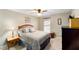 Comfortable bedroom featuring neutral tones, a ceiling fan and light, with a window view at 16272 Se 89Th Ct, Summerfield, FL 34491