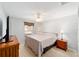 Cozy bedroom with neutral tones, ceiling fan, and natural light from a window at 16272 Se 89Th Ct, Summerfield, FL 34491