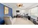 Bedroom with guitars, drums, blue accent wall, and a cozy recliner at 16272 Se 89Th Ct, Summerfield, FL 34491