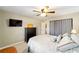 This is a well-lit bedroom featuring a large dresser and carpeted floor at 16272 Se 89Th Ct, Summerfield, FL 34491