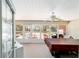 Enclosed back porch with ceiling fan and multiple windows looking out to back yard at 16272 Se 89Th Ct, Summerfield, FL 34491