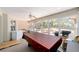 Enclosed porch with pool table and view of outdoor seating area at 16272 Se 89Th Ct, Summerfield, FL 34491