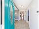 Bright foyer with tile flooring and a glimpse into the living area, showcasing an open and welcoming home design at 16272 Se 89Th Ct, Summerfield, FL 34491