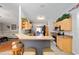 Open kitchen with breakfast bar, stainless appliances, and view to living area at 16272 Se 89Th Ct, Summerfield, FL 34491