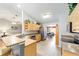 Open kitchen with bar seating, stainless steel appliances, and views into the living and dining areas at 16272 Se 89Th Ct, Summerfield, FL 34491
