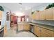Well-lit kitchen features stainless steel appliances, tile flooring, and wooden cabinetry at 16272 Se 89Th Ct, Summerfield, FL 34491