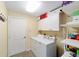 Functional laundry room with white cabinets, a washer, and a dryer at 16272 Se 89Th Ct, Summerfield, FL 34491