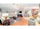 Bright living space featuring modern furnishings, wood flooring, and an open layout connecting to the kitchen at 16272 Se 89Th Ct, Summerfield, FL 34491