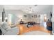 Cozy living room with vaulted ceilings, ceiling fan, hardwood floors, and ample seating for entertaining guests at 16272 Se 89Th Ct, Summerfield, FL 34491