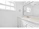 Bright bathroom featuring a vanity with drawers, a mirror, and a window at 1818 Se Lake Weir Ave, Ocala, FL 34471