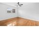 Bedroom with hardwood floors, a window, a ceiling fan, and white walls at 1818 Se Lake Weir Ave, Ocala, FL 34471