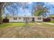 Charming single-story home with a well-maintained front yard and fountain feature under a mature tree at 1818 Se Lake Weir Ave, Ocala, FL 34471
