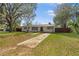 Classic single-story home with a spacious front yard, mature tree, and long driveway at 1818 Se Lake Weir Ave, Ocala, FL 34471
