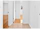 Hallway with tile flooring and views into rooms with hardwood floors and neutral walls at 1818 Se Lake Weir Ave, Ocala, FL 34471