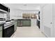 Modern kitchen with stainless steel appliances, green cabinets, and a laundry area at 1818 Se Lake Weir Ave, Ocala, FL 34471