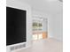 Bright living room with white walls, light floors, and an open doorway at 1818 Se Lake Weir Ave, Ocala, FL 34471