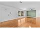 Bright living room with hardwood floors, a ceiling fan, and a large window at 1818 Se Lake Weir Ave, Ocala, FL 34471