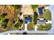 Aerial view of a home with a long driveway, surrounded by lush greenery, and a dark roof at 19 Juniper Pass, Ocala, FL 34480