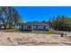 Rear view of a single-Gathering home featuring a dark roof and a spacious yard at 19 Juniper Pass, Ocala, FL 34480