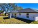 Back exterior of home with a covered patio and green lawn at 19 Juniper Pass, Ocala, FL 34480