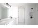 Modern bathroom with a double vanity and walk-in shower featuring beautiful white tile at 19 Juniper Pass, Ocala, FL 34480