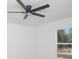 Bright bedroom featuring a ceiling fan and a large window letting in plenty of natural light at 19 Juniper Pass, Ocala, FL 34480