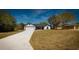 Charming single-story home with a two-car garage, red front door, dark trim, and well-manicured lawn at 19 Juniper Pass, Ocala, FL 34480