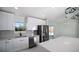 Modern kitchen featuring stainless steel appliances, island counter and sleek, white cabinets, filled with light at 19 Juniper Pass, Ocala, FL 34480