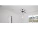 Bright living room features a ceiling fan, and a large window letting in plenty of natural light at 19 Juniper Pass, Ocala, FL 34480