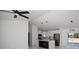 Bright living room featuring an open layout, a ceiling fan, and seamless access to the modern kitchen at 19 Juniper Pass, Ocala, FL 34480