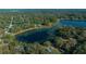 Aerial view of the property showcasing its location on a tranquil lake surrounded by trees at 221 Se 167Th Ct, Silver Springs, FL 34488
