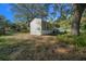 Exterior view of a well-maintained grey home featuring landscaped yard and wooden fence at 221 Se 167Th Ct, Silver Springs, FL 34488