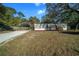 Charming home features a gray exterior with a carport and well-maintained landscaping at 221 Se 167Th Ct, Silver Springs, FL 34488