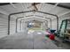Spacious garage with metal walls, lighting, and a fan provides ample space for storage and projects at 221 Se 167Th Ct, Silver Springs, FL 34488